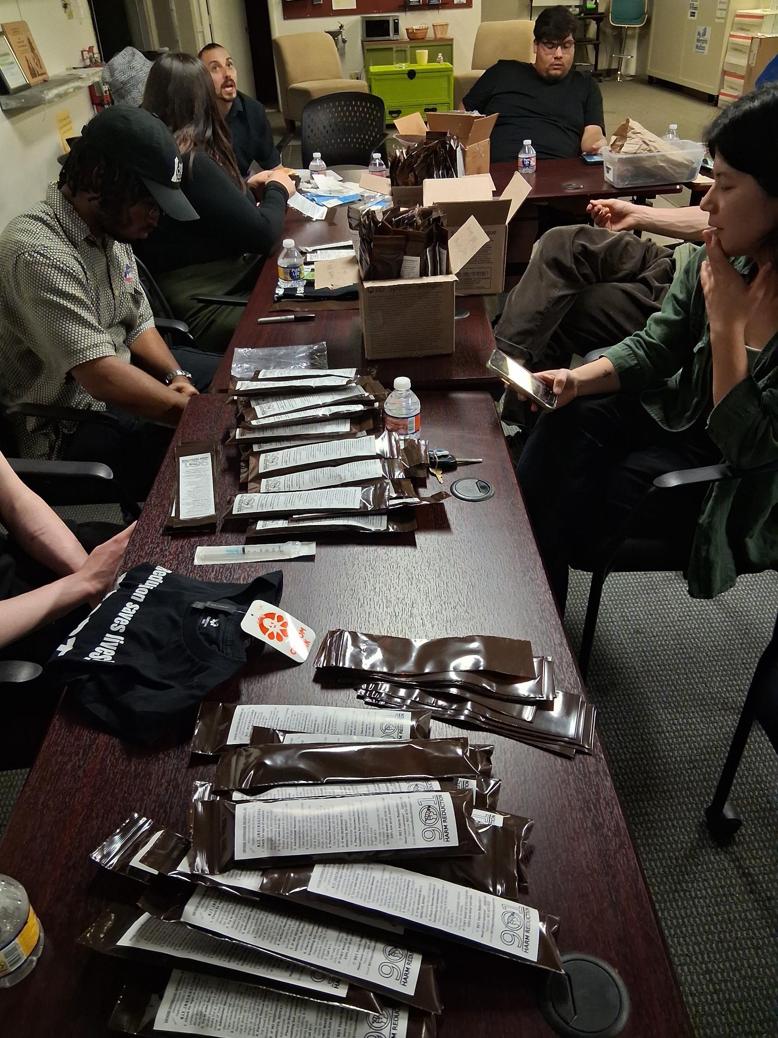 group of people putting together opioid overdose reversal kits